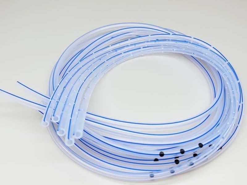 Bi-colour silicone tubing with dual colour identification stripes